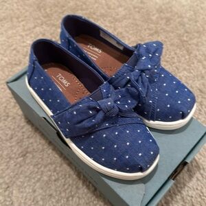Brand new. Toddler size 9 Toms
